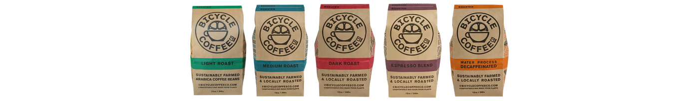 Bicycle Coffee 12 oz bags lined up by roast: Light, Medium, Dark, Espresso, and Decaf.