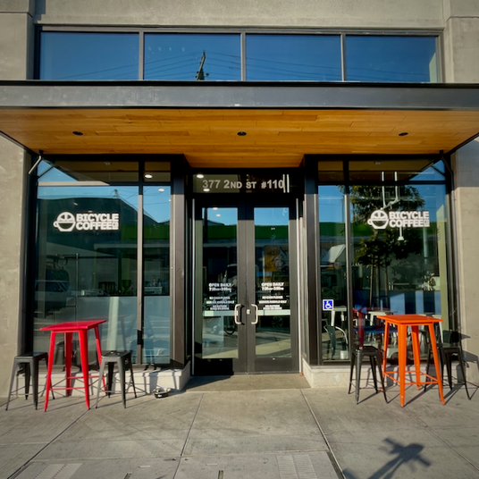 Bicycle Coffee storefront at 377 2nd St, Oakland, featuring the cafe and roastery entrance with outdoor seating.