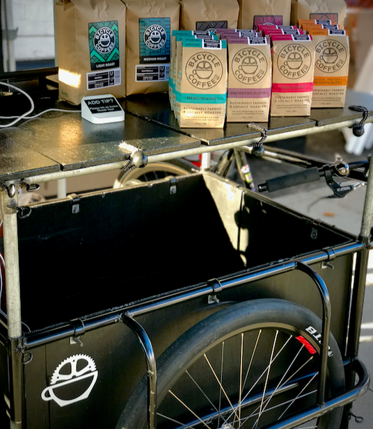 Bicycle Coffee bags displayed on a cart at the Grand Lake Farmers market in Oakland.