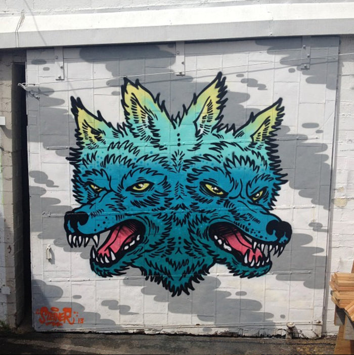 Gemini Wolf mural by Andrew Steiner painted on the door of Bicycle Coffee’s former Oakland roastery near Lake Merritt.