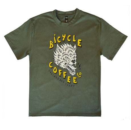 Olive green T-shirt featuring a bold graphic of a snarling three-eyed wolf, with yellow ‘Bicycle Coffee Co’ text and ‘Oakland and Tokyo’ printed below.